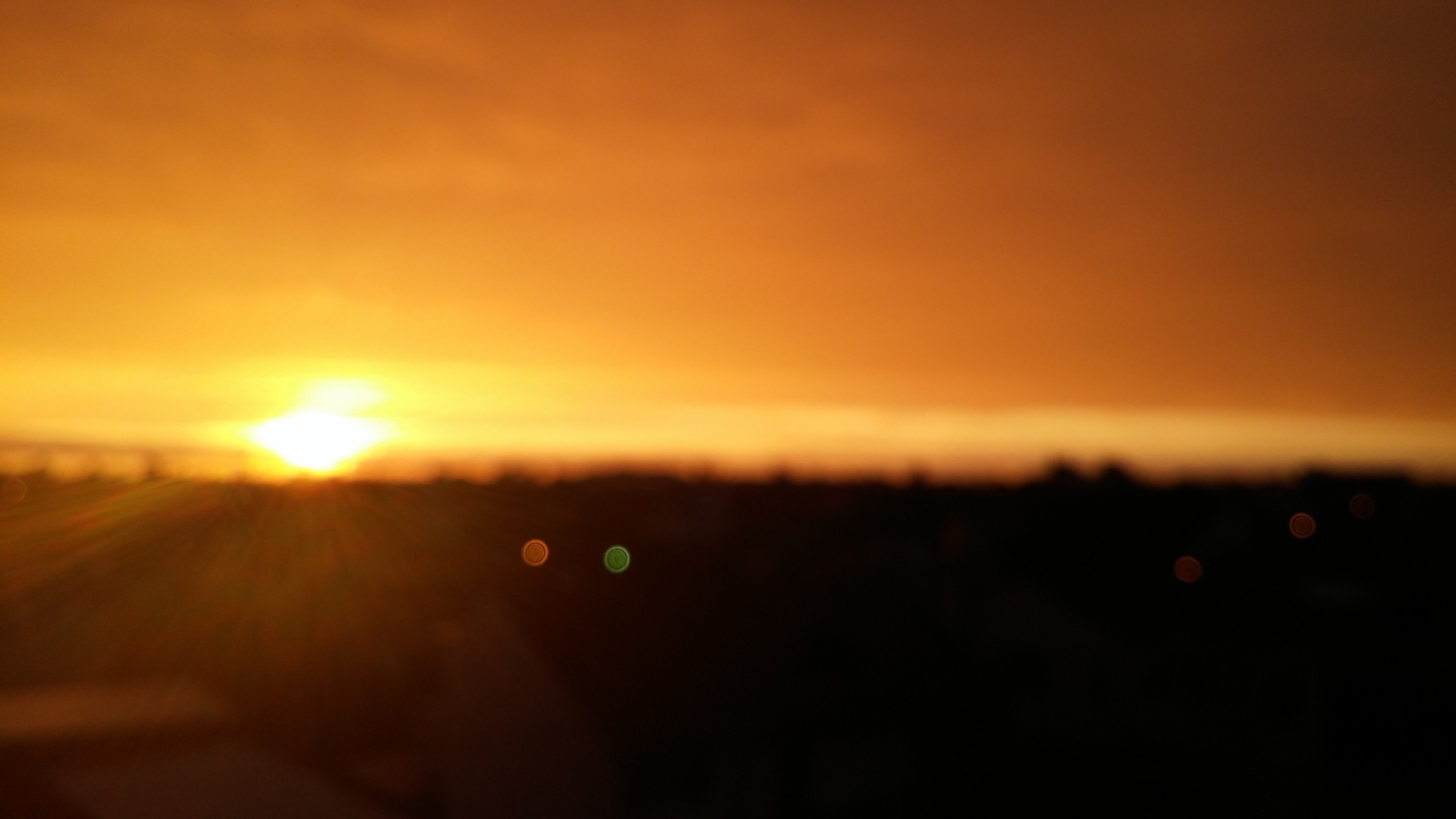 sunset, Blurred, Lights, Sun rays, Rain Wallpaper
