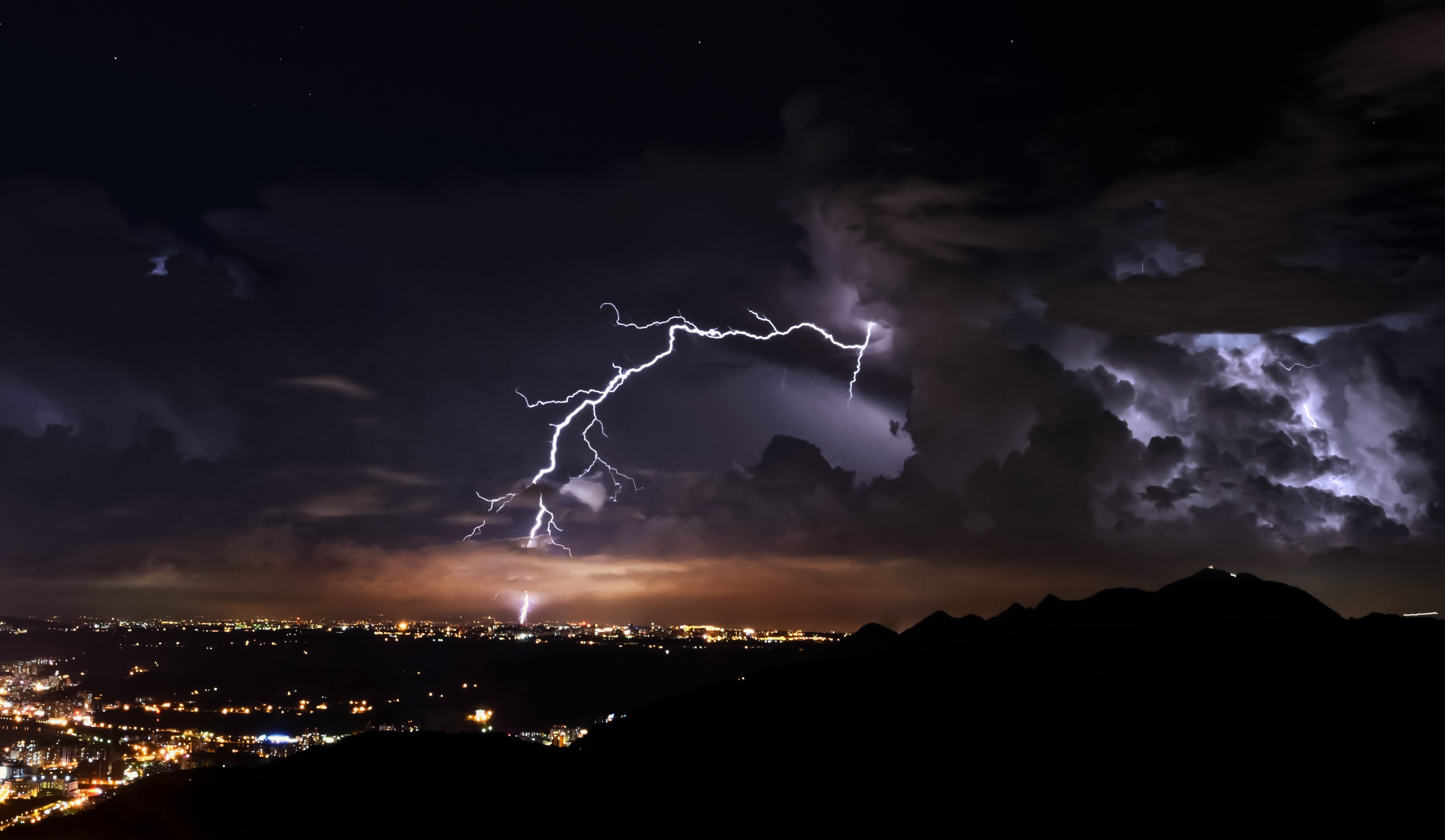 nature, Landscape, Clouds, Lightning, Night, Storm, Cityscape, City lights, Mountains, Silhouette Wallpaper
