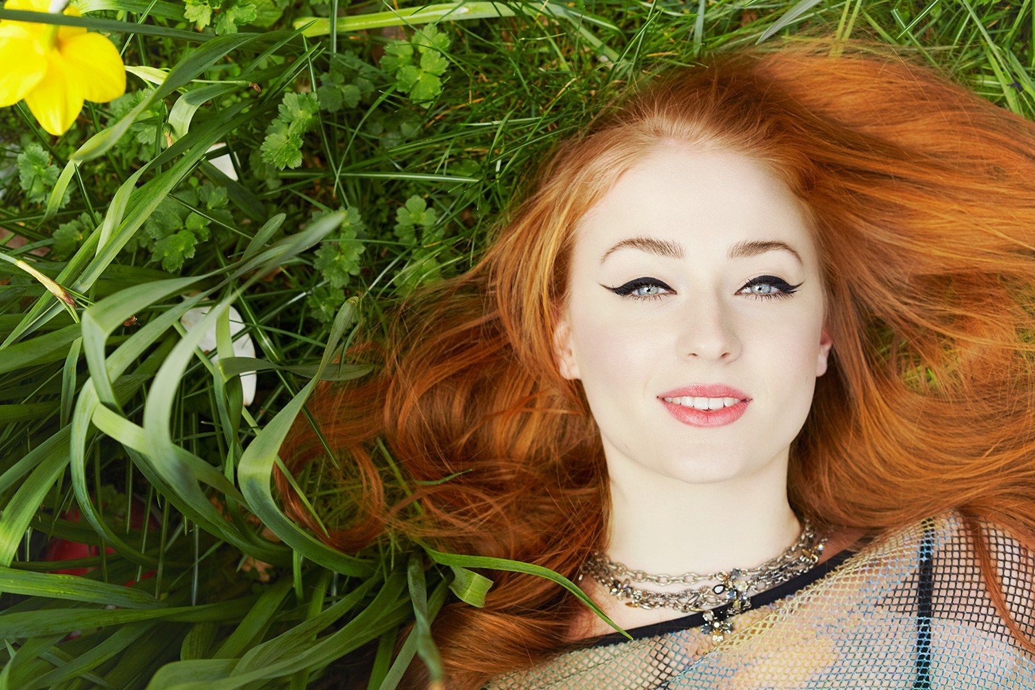 women, Model, Redhead, Long hair, Face, Blue eyes, Red lipstick, Open mouth, Smiling, Sophie Turner, Women outdoors, Lying down, Nature, Grass, Makeup, Yellow flowers Wallpaper
